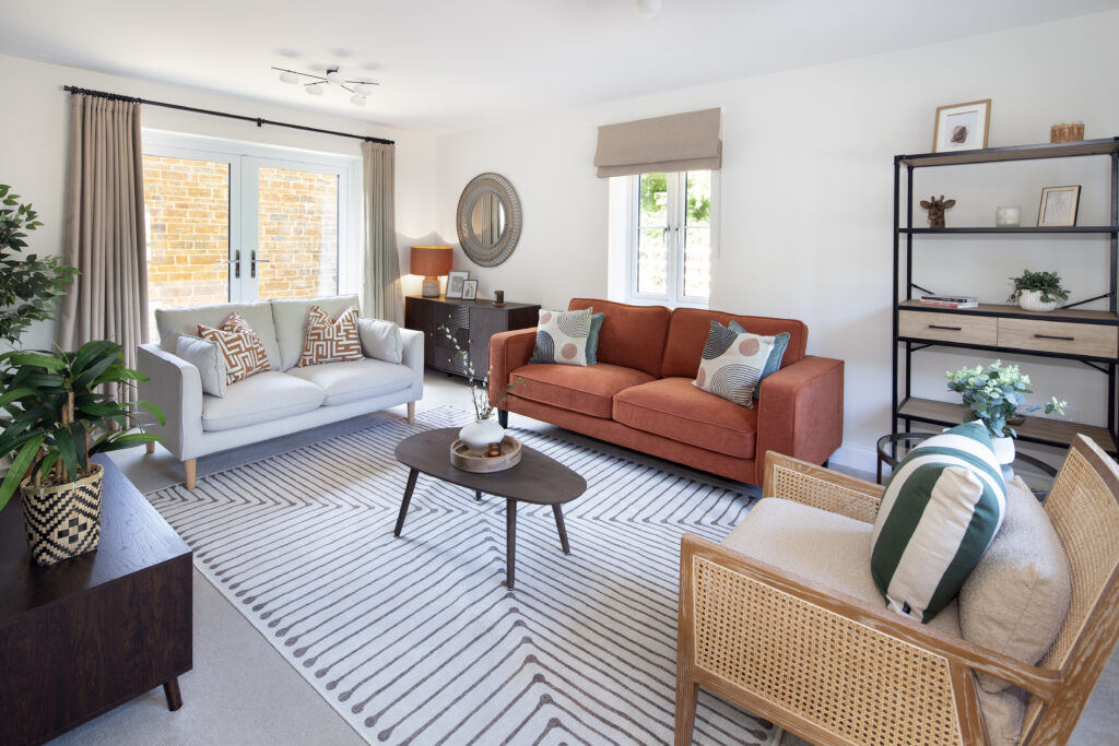 Warm, elegant show home living room by JT Interiors in the Cotswolds