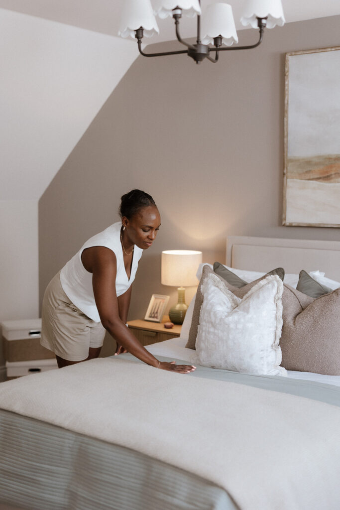 A member of our design team putting the final touches to a bedroom