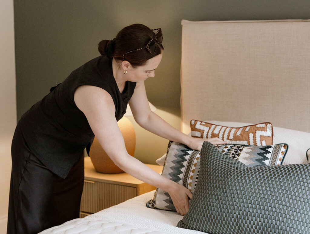 Our interior design expert finessing beautiful cushions