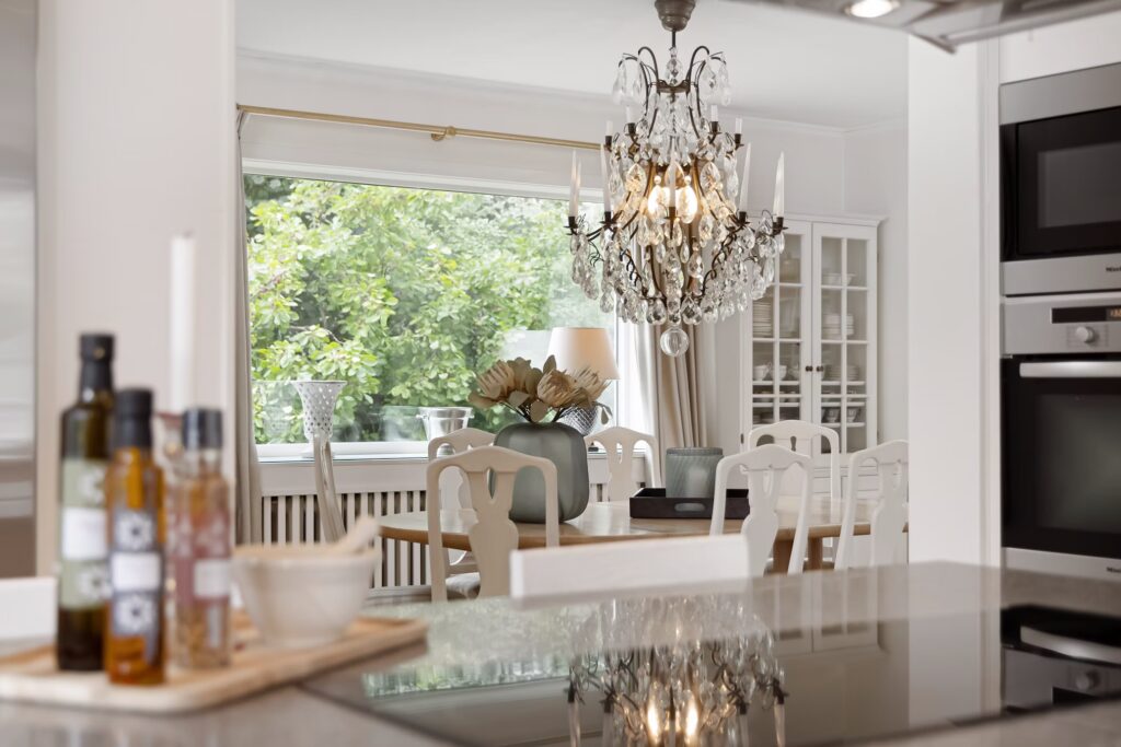 a stunning baroque chandelier used in a contemporary kitchen by lisa anna